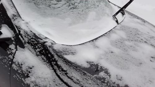 Car Covered in Snow in Winter Landscape