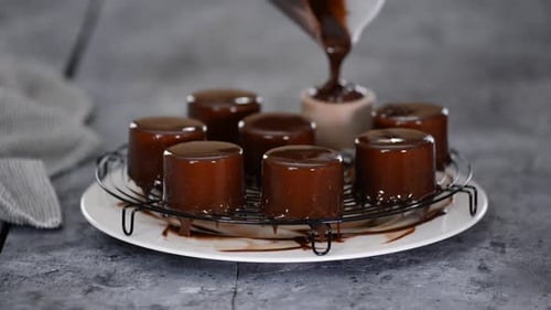 Pouring Chocolate Over Mousse Cakes