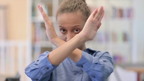 Young Adult Woman Says No with Arms