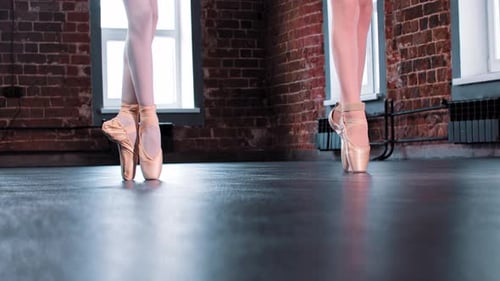 Ballet Dancers Standing En Pointe in Studio
