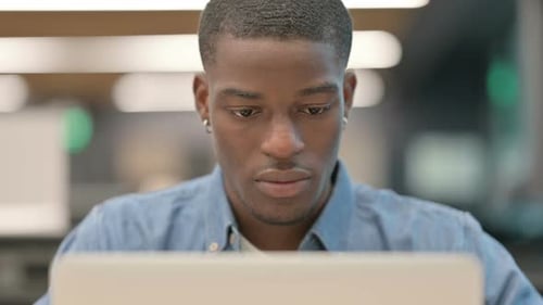 Close Up of Man Concentrating on Laptop Screen