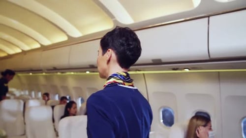 Airplane Cabin with Passengers and Airline Employees