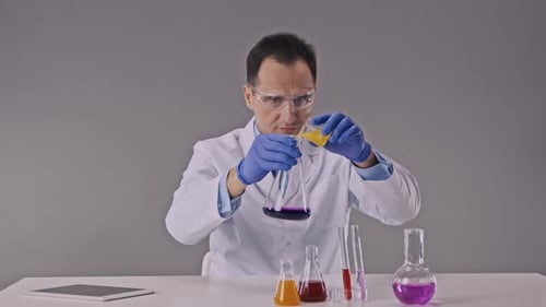 Scientist Works in Chemistry Lab with Reaction Tubes Performing Science Experiments