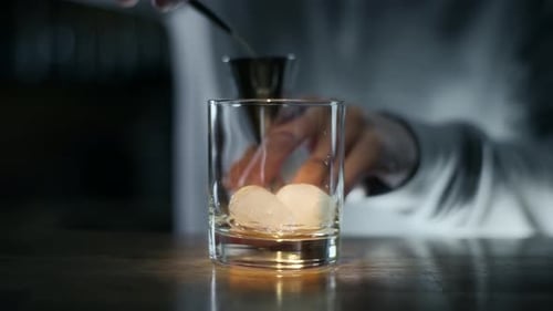 Bartender Making a Cocktail in Rocks Glass