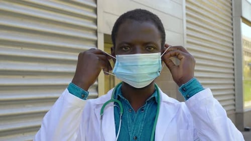 Doctor Putting on a Protective Surgical Mask