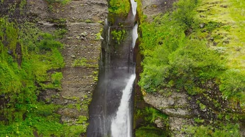 Water Falling Flowing Down Beautiful Vibrant Green Cascade.