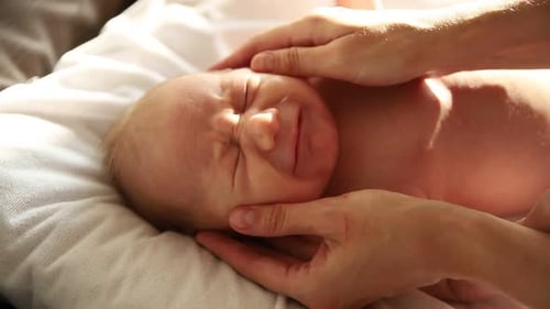 Crying Infant Getting Face Massage at Home
