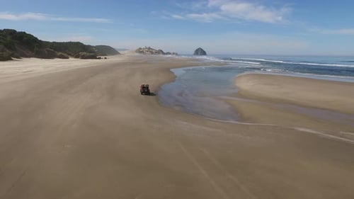 Aerial shot of 4x4 off road vehicle driving on beach