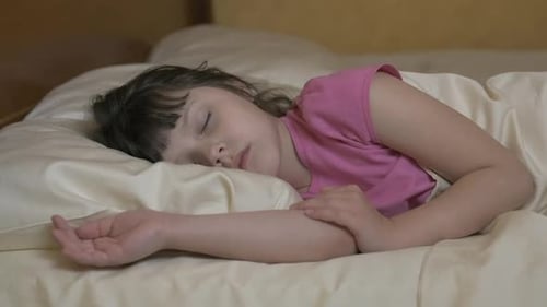 Child Sleeping Soundly in Bed at Home