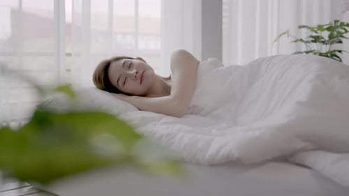 Woman Sleeping Peacefully in Bed at Home