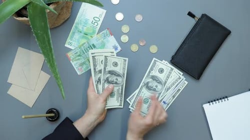 Counting Money on Desk at Business Workplace