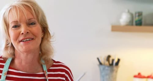 Woman Smiling in a Bright Kitchen