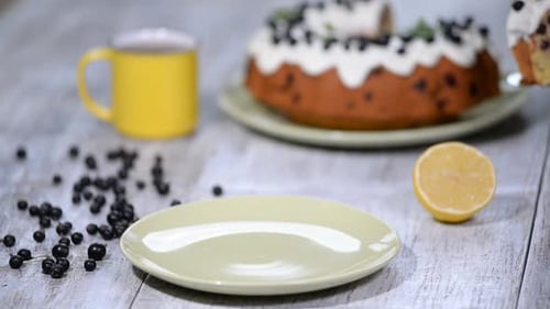 Slice of Blueberry Cake Being Placed on Plate