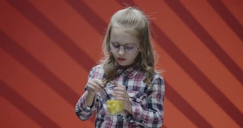 Child Eats Fruit from Cup, Close Up