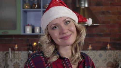 Smiling Woman Wearing Santa Hat in Festive Home