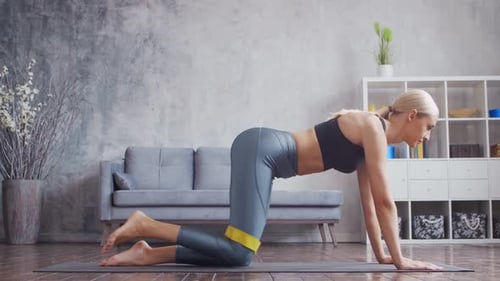 Woman Exercising with Resistance Band at Home