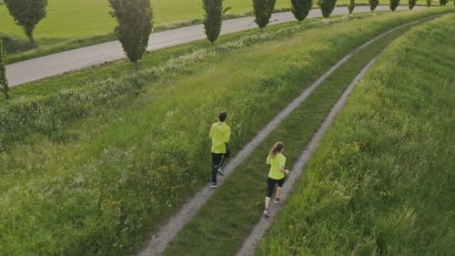 Couple Running Together on Rural Path