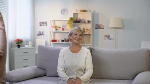 Woman Receives Birthday Gifts from Family at Home