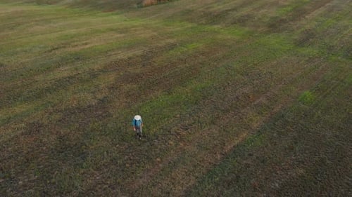 Farmer Walking in Mown Field