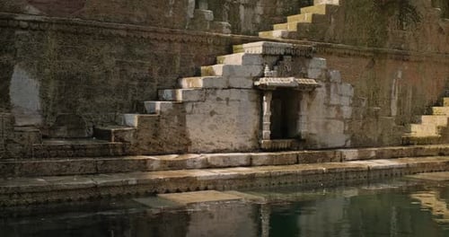 Ancient Stepwell with Intricate Stonework and Tranquil Water