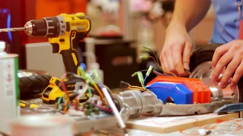 Close Up of Person Repairing Electric Scooter