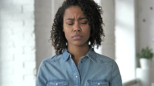 Sad Young African Girl Feeling Upset While Looking at Camera