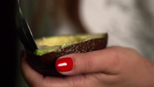 Scooping Out an Avocado with Spoon