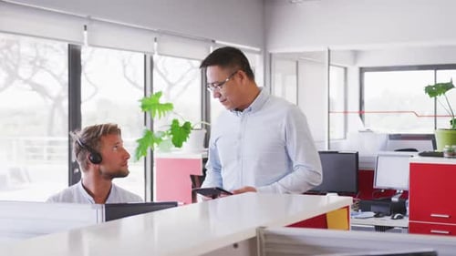Senior Geschäftsmann spricht in Zeitlupe mit jungen Geschäftsleuten im modernen Büro
