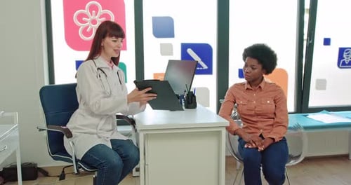 The Patient Is an African American Woman Listening To the Doctor in the Clinic