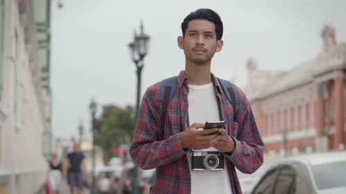 Young Adult Using Phone in Urban Setting