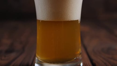Close Up of Refreshing Beer Glass with Foam