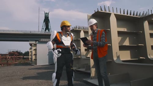 Construction Workers Inspecting Project with Exoskeleton Technology