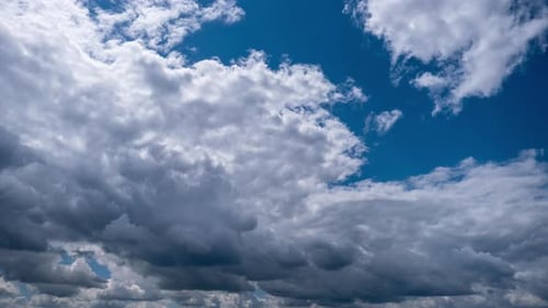 Billowing Clouds Passing in a Blue Sky