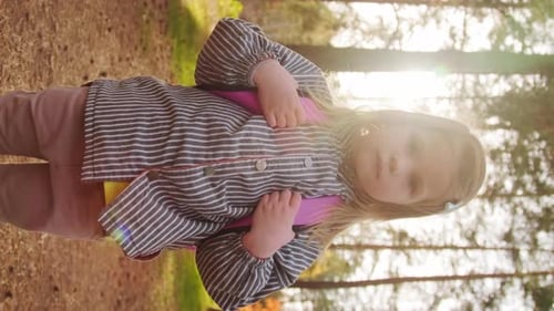 Vertical Portrait of Little Girl in Forest