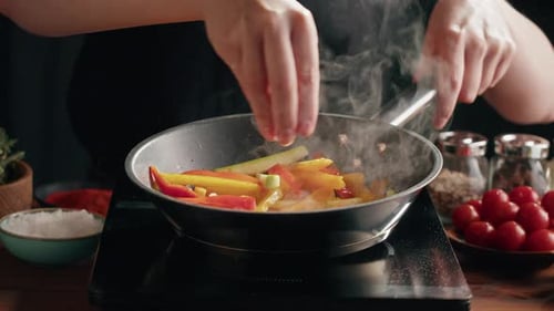Vegetables Being Stir Fried with Salt