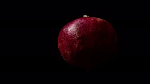 Pomegranate On A Black Background.