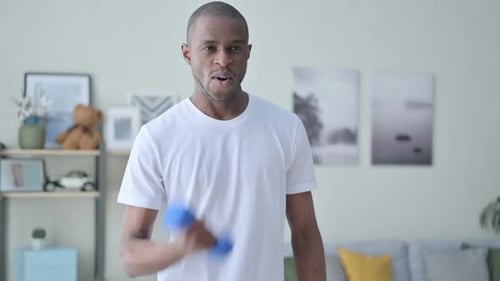 Close Up of Athletic African Man Working Out with Dumbbells