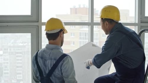 Engineers Review Blueprint in Urban Building