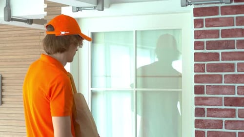 Delivery man and uniform send delivering order bag in front of customer house