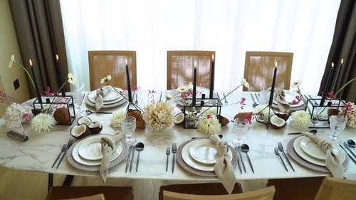 Stylized Table Setting with Candles and Coconuts