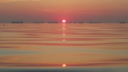 Vivid Sunrise or Sunset Over Calm Ocean