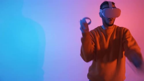 Man Using Virtual Reality Headset and Controllers
