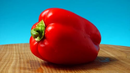 Fresh Red Bell Pepper on Wooden Cutting Board