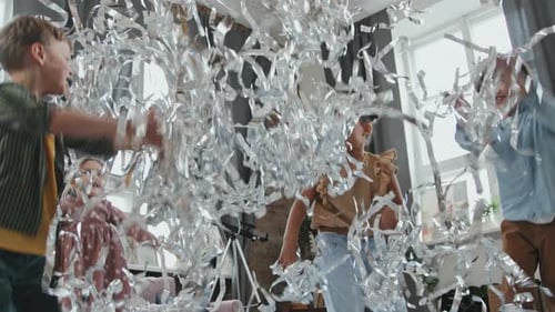Excited Children Throwing Silver Streamers