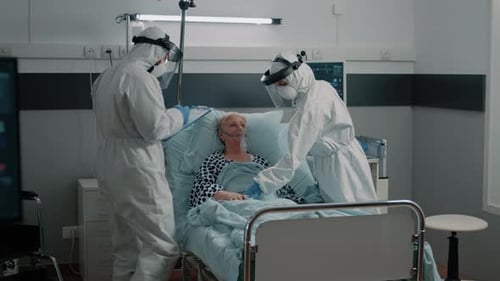 Healthcare Workers Attending to a Patient in Hospital