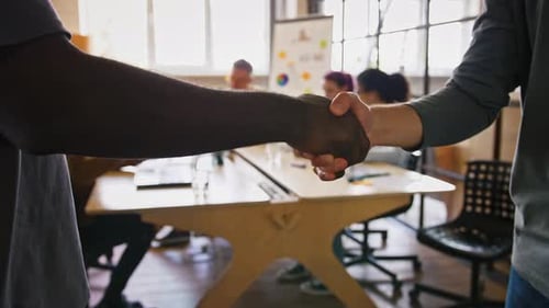 Business Handshake in Sunny Modern Office