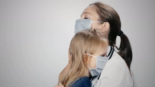 Doctor Comforting a Child Patient with a Hug