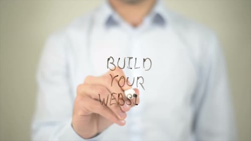 Build Your Website Man Writing on Transparent Screen