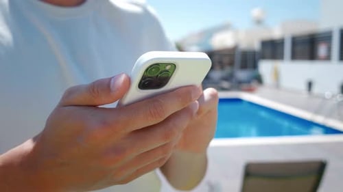 Using Smartphone by Swimming Pool on Vacation