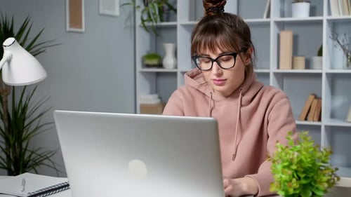 Tired Woman Working at Laptop in Home Office